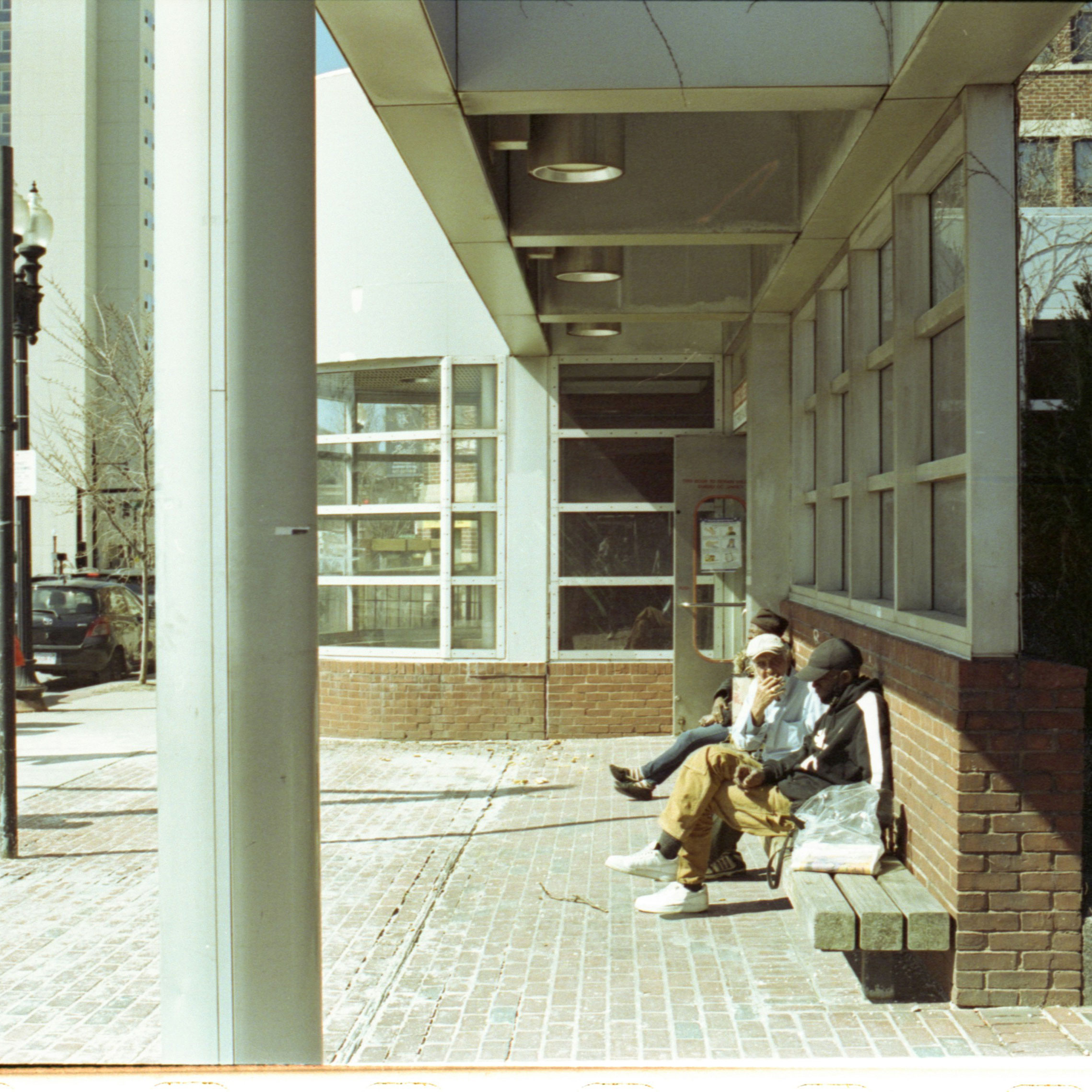 People sitting by a building