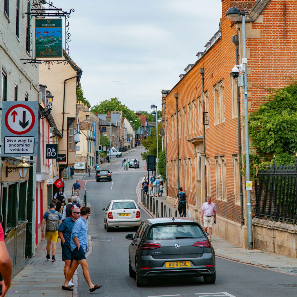 People standing by a road in a small town