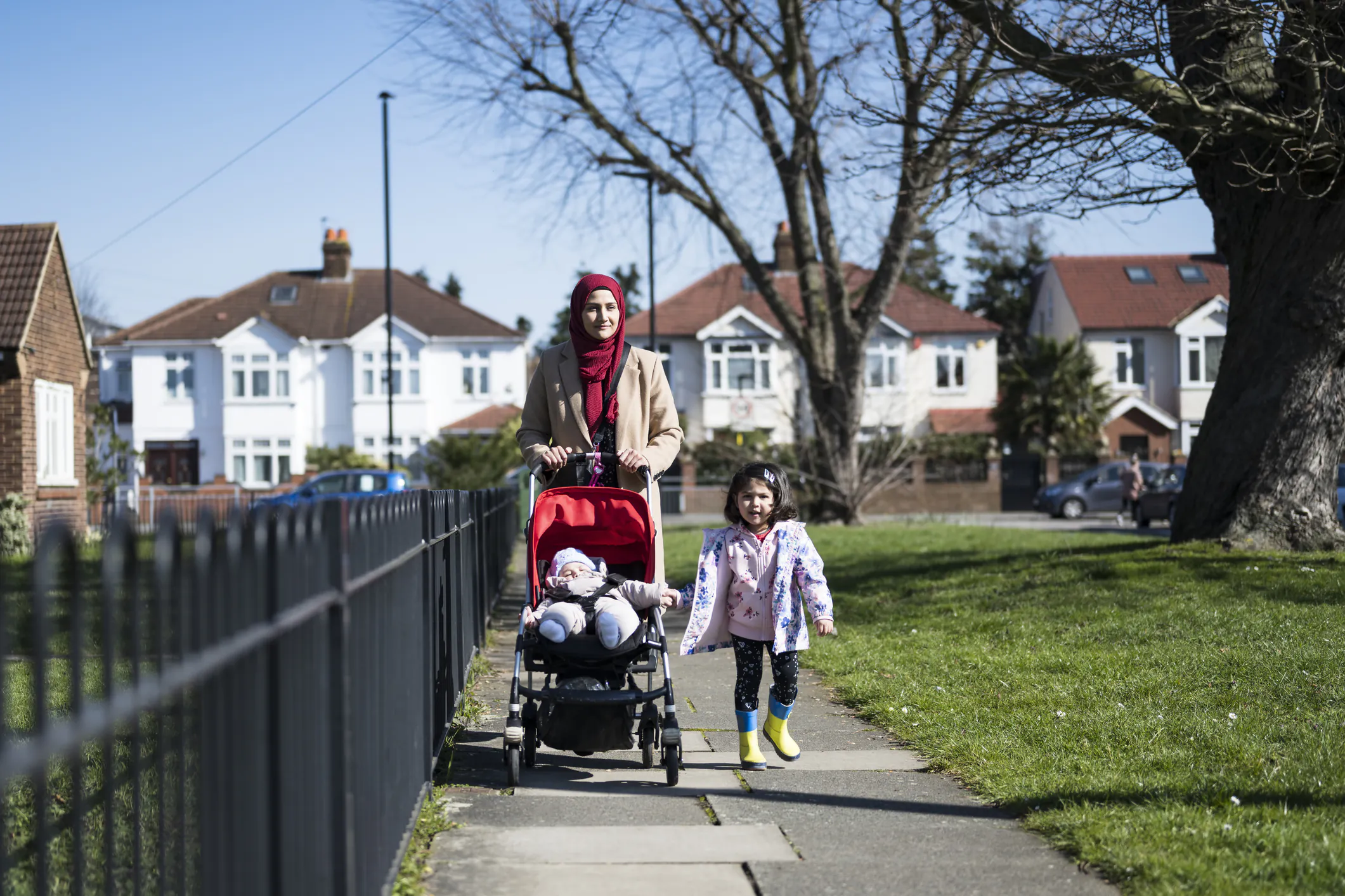 British Asian mother and young children enjoying exercise