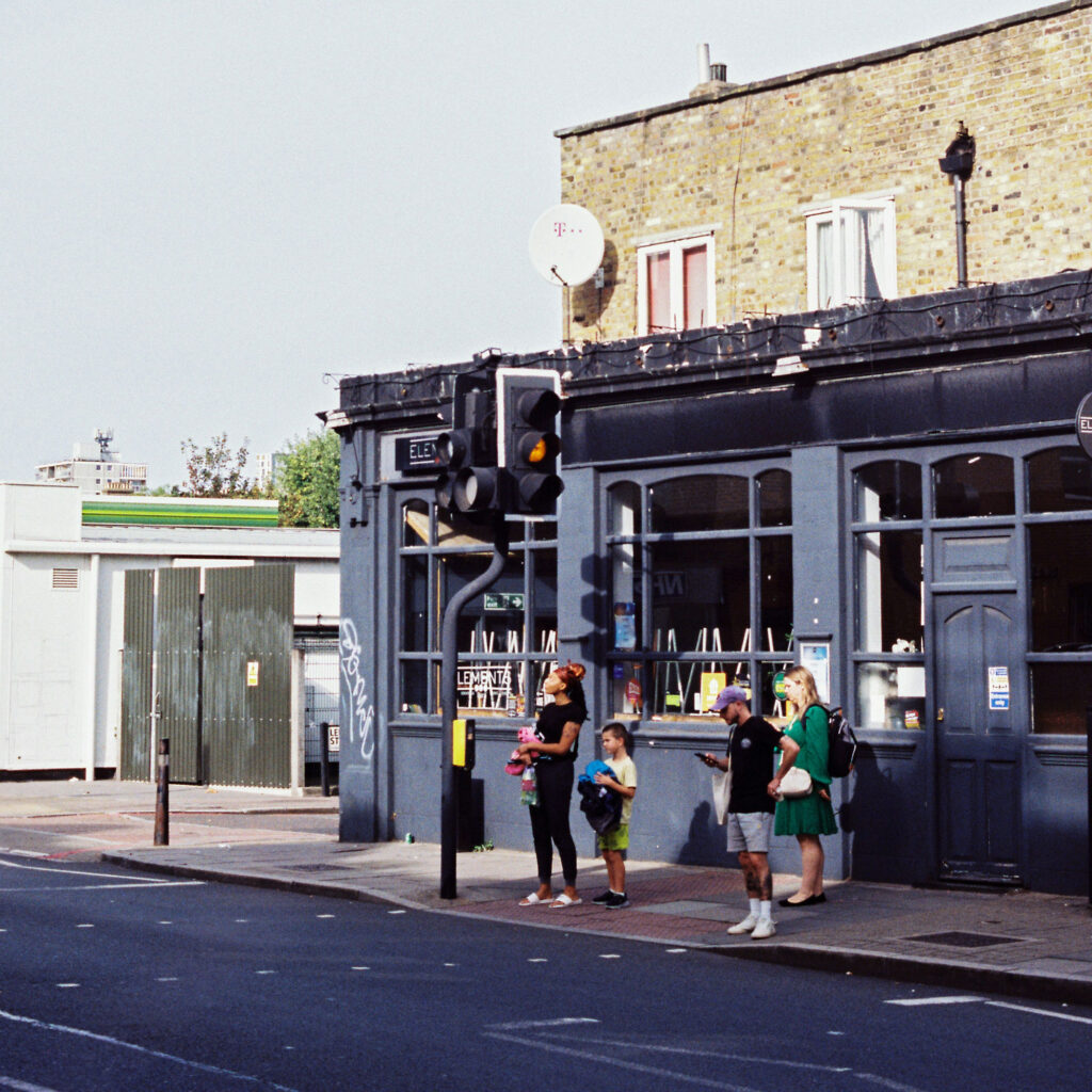 A group of people standing by the side of a road
