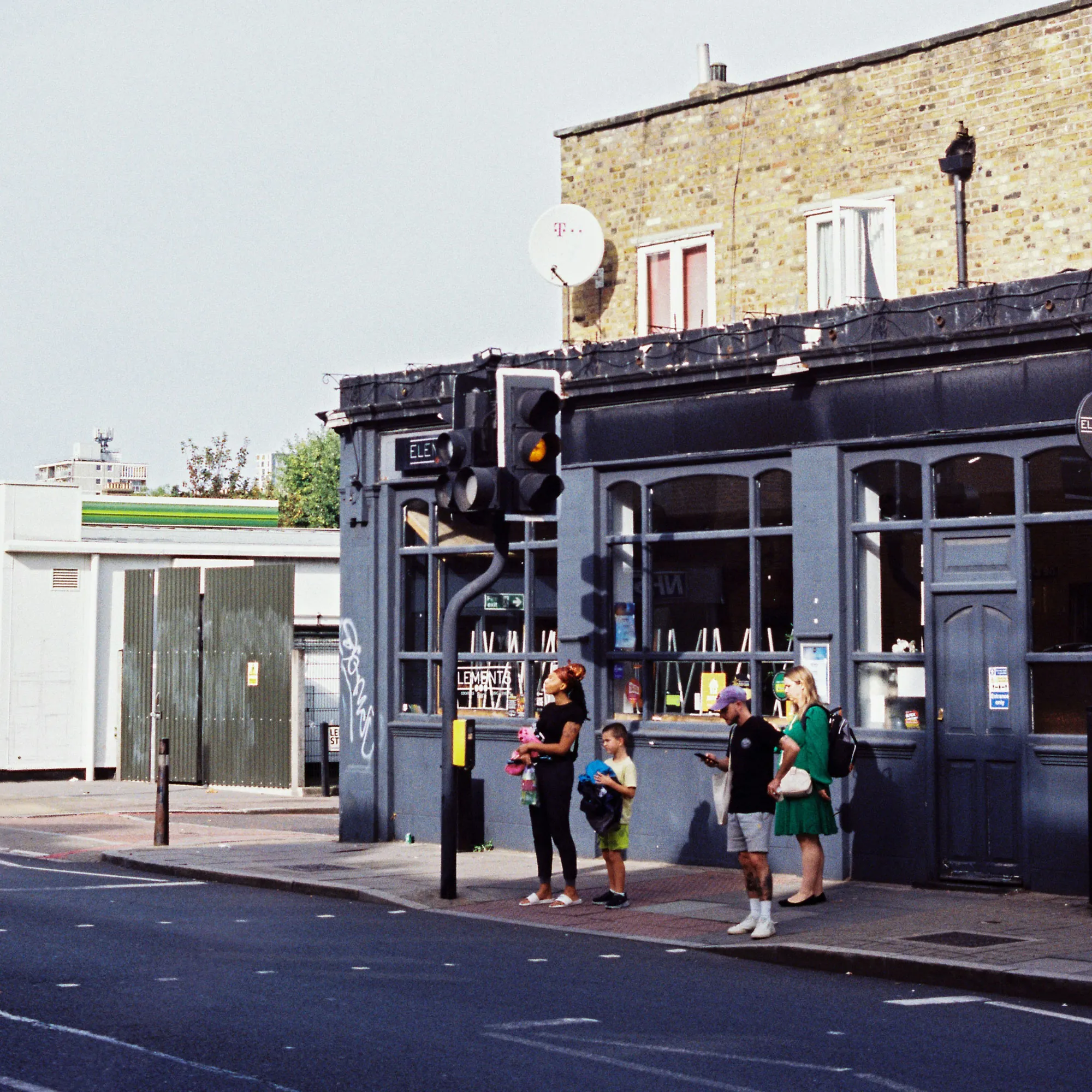 A group of people standing by the side of a road